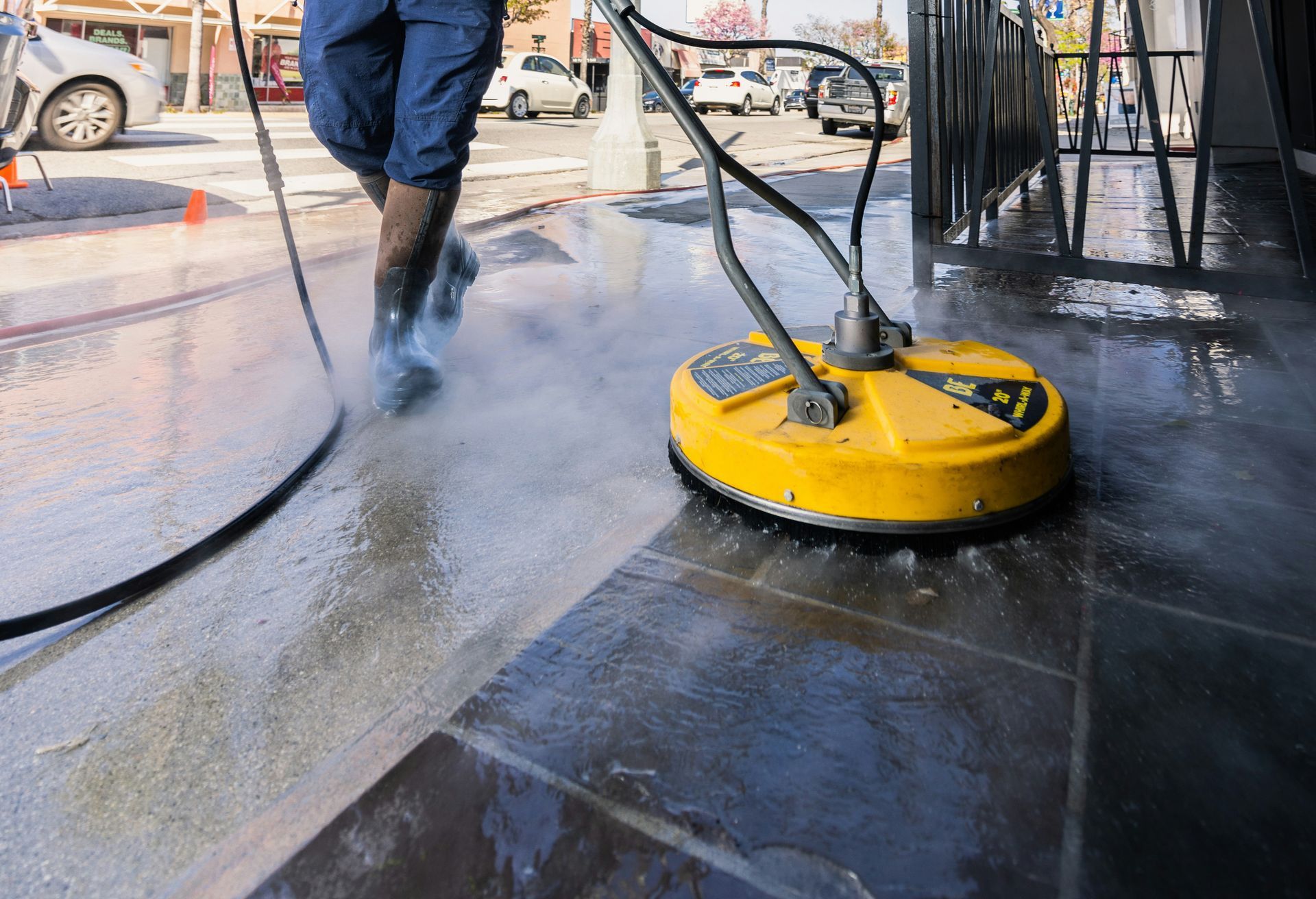 a man in a yellow vest is cleaning a street
